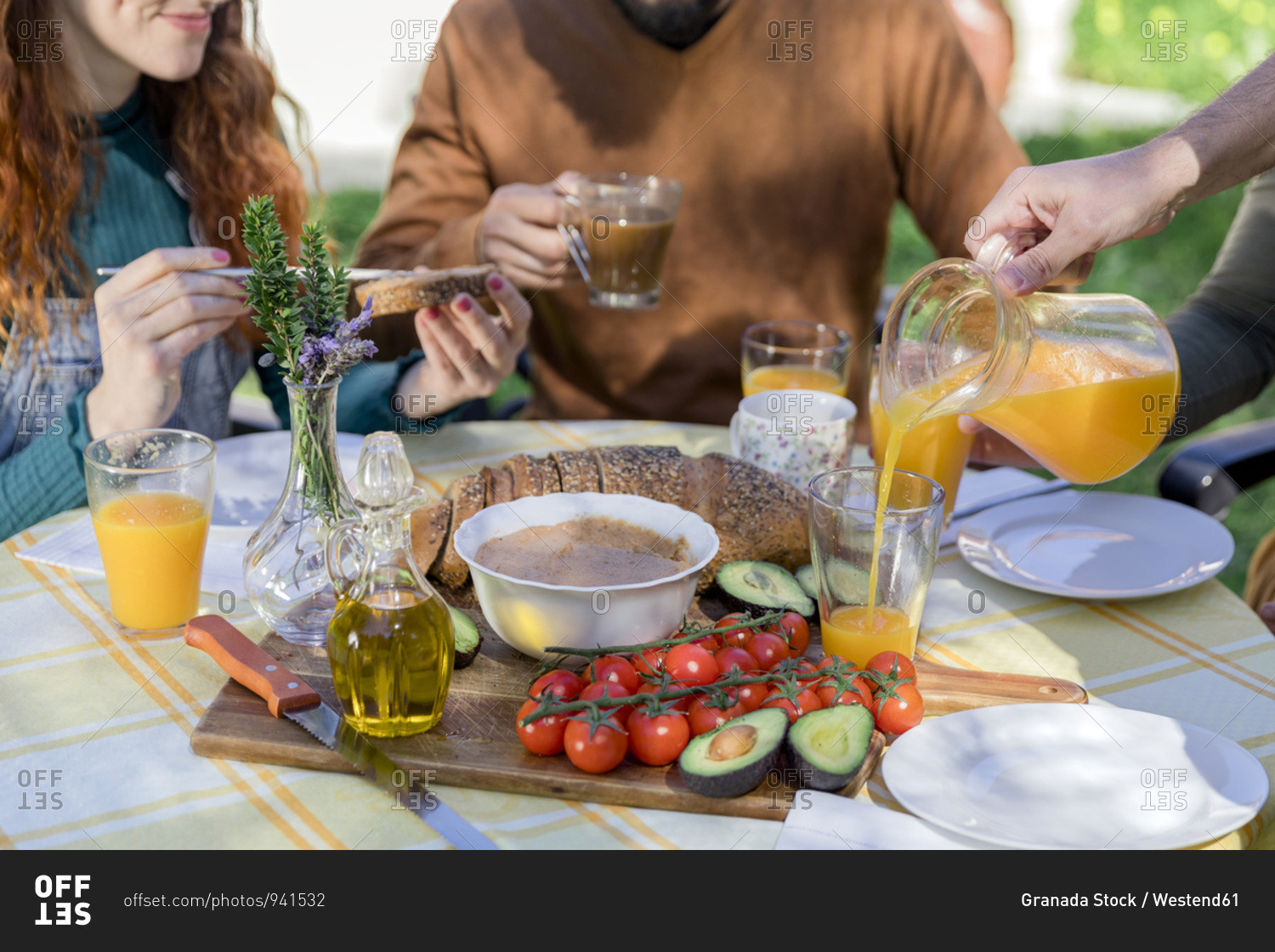 Close-up of friends enjoying a healthy vegan breakfast outdoors