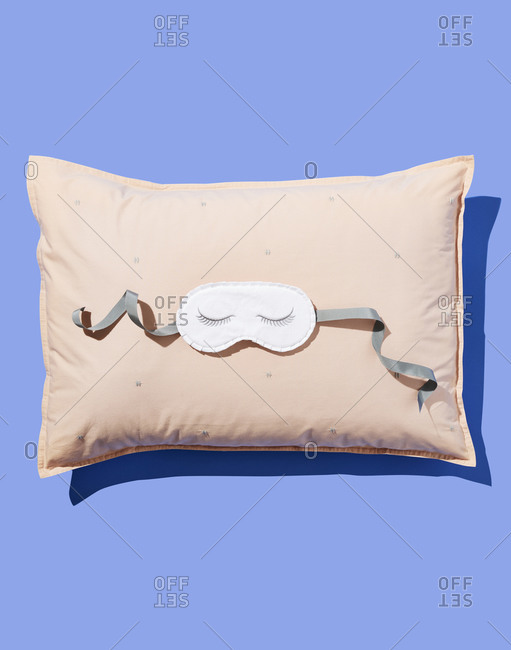 Embroidered Eye Mask on Pink Pillow