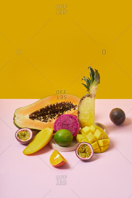 Still life with tropical fruits on colorful background