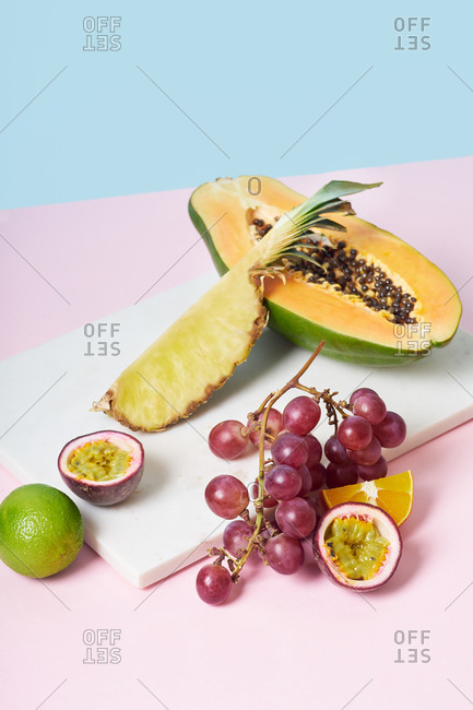 Still life with tropical fruits on colorful background