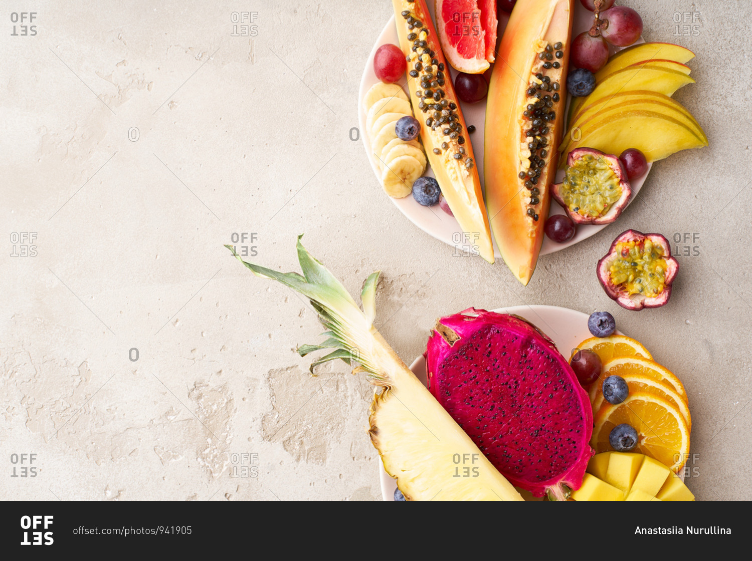 Colorful tropical summer fruits and berries. Papaya, mango, passion fruit, banana, grapes sliced and served on a plate. Summer fruits platter