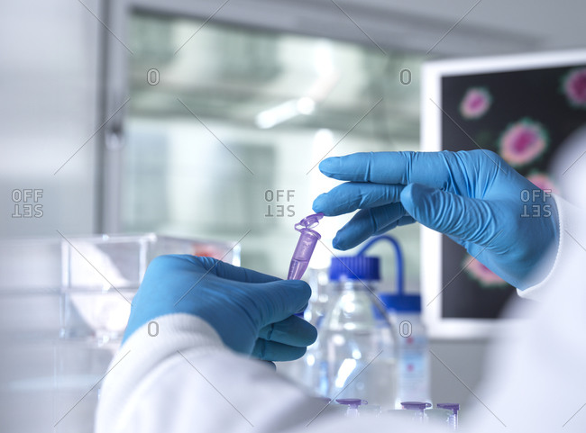 Pharmaceutical research, Scientist preparing a sample vial for analytical testing in the laboratory used in DNA, medical and pharmacology research.