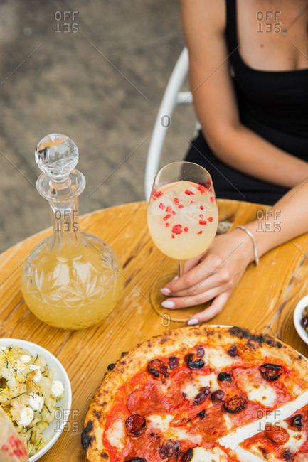 Woman having cocktails and eating a meal