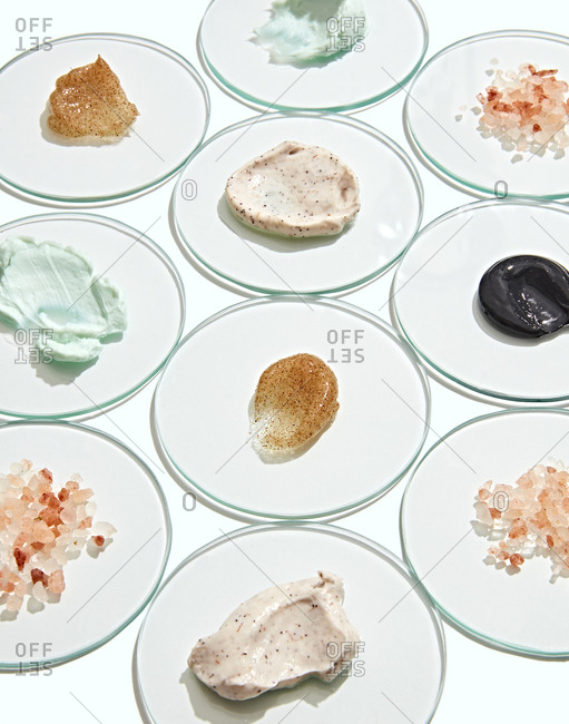 Variety of skincare products displayed on glass circles