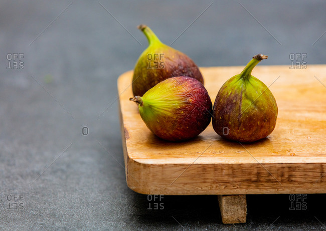 Fresh common figs on wooden desk