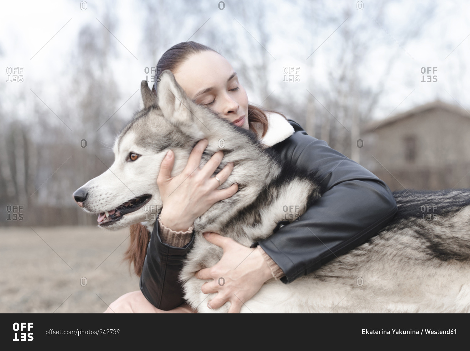 Happy woman cuddling her dog