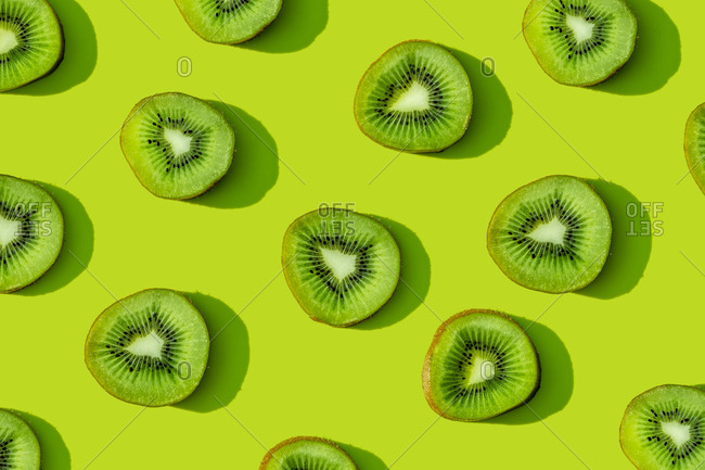 Kiwi fruit pattern on green background