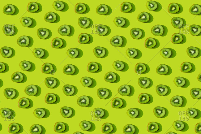 Kiwi fruit pattern on green background