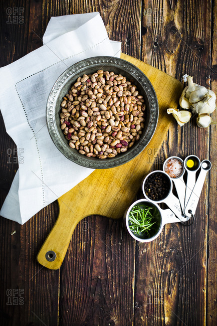 Bowl of pinto beans- salt and pepper- garlic- rosemary and olive oil