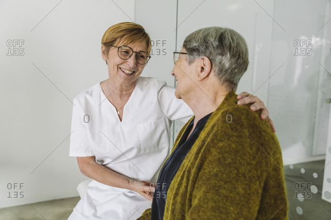 Doctor's assistant encouraging senior patient in medical practice