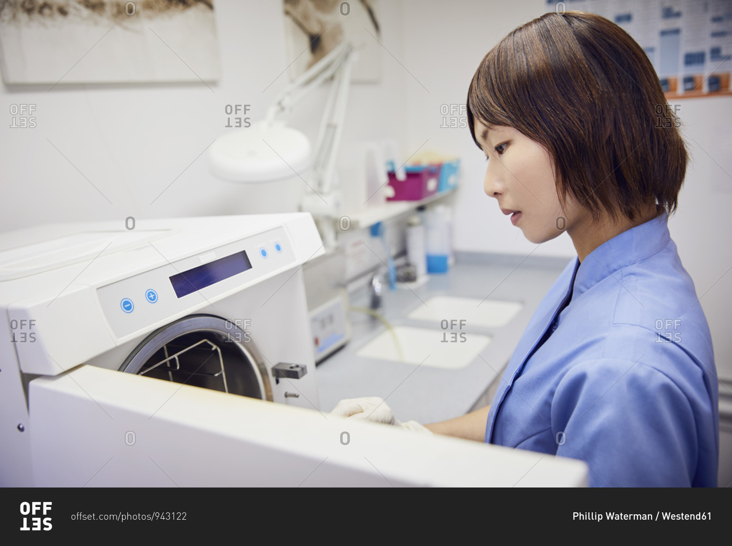 Dental assistant in practice sterilizing instruments