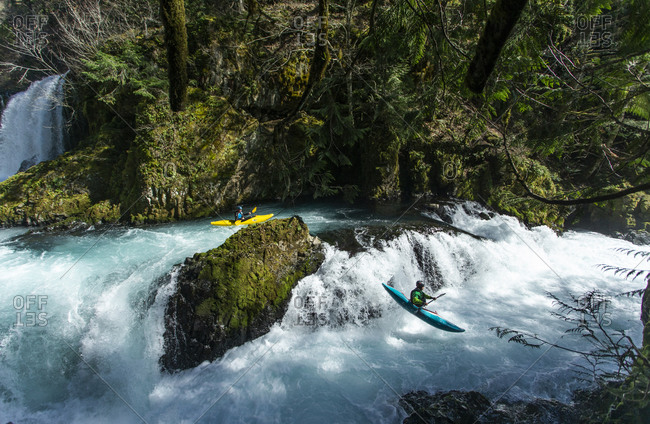 White Salmon, WA, United States - March 18, 2020: Two kayakers descends the Little White Salmon River in WA.