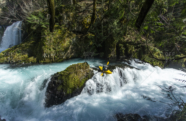 White Salmon, WA, United States - March 18, 2020: A kayaker descends the Little White Salmon River in WA.