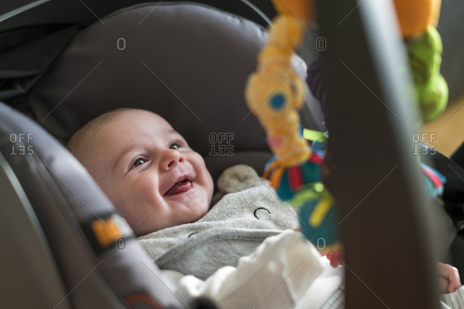 High angle view of smiling baby in car seat