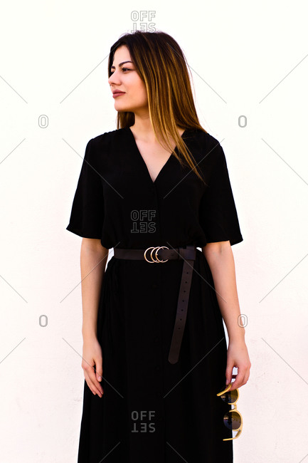 Attractive Caucasian woman poses in an elegant black dress