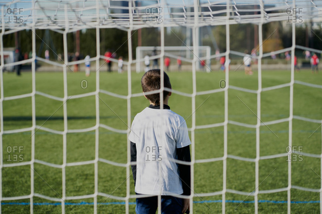 Gatekeeper children soccer player in action. stadium