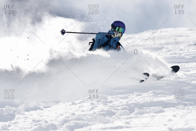 Male skier swerve skiing down mountain, Alpe-d'Huez, Rhone-Alpes, France