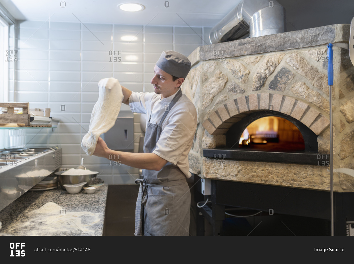 Chef tossing and stretching the dough for Pinsa Romana, a Roman style pizza blend reducing sugar and saturated fat, containing rice and soy with less gluten