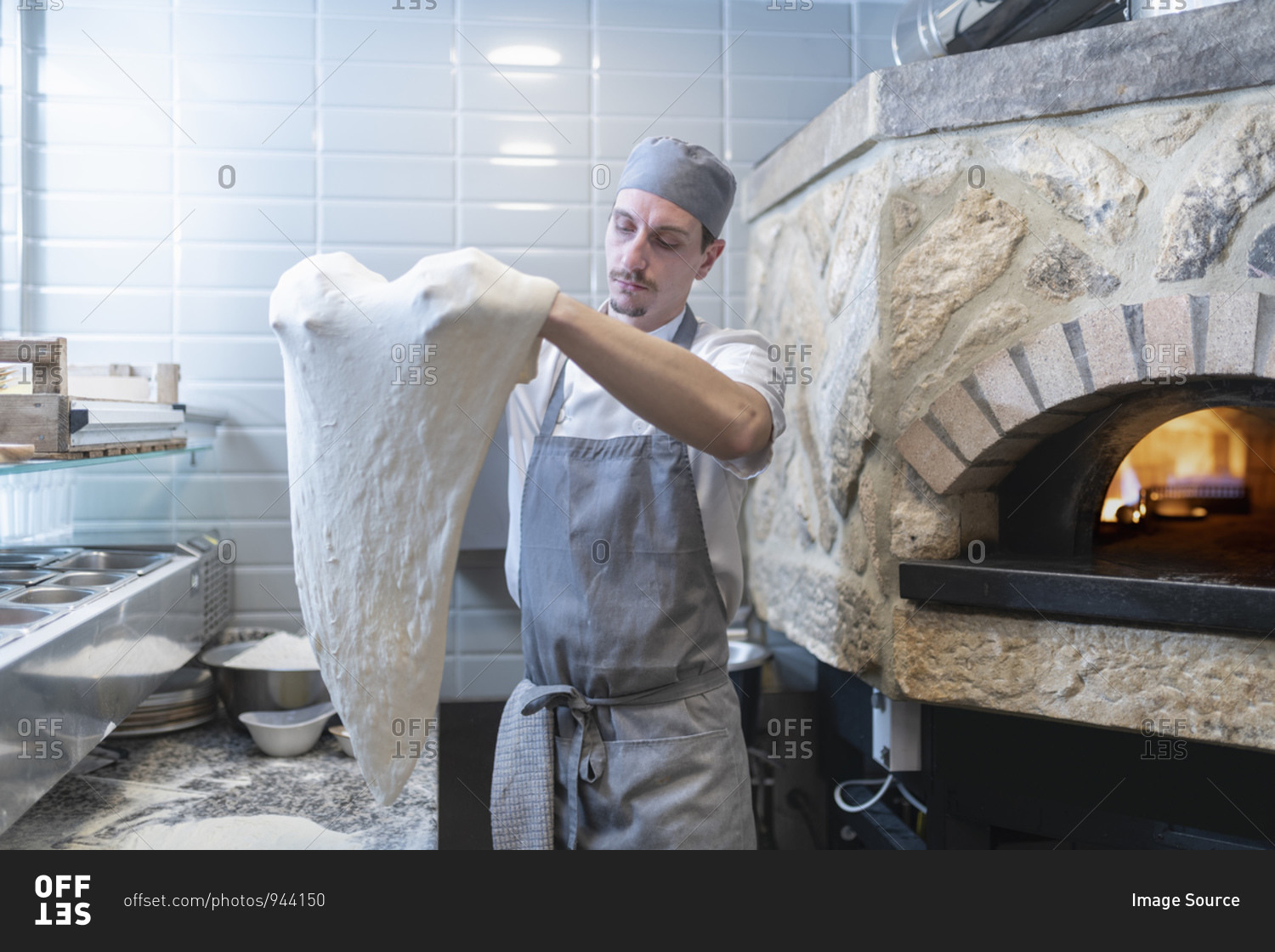 Chef shaping the dough for Pinsa Romana, a Roman style pizza blend reducing sugar and saturated fat, containing rice and soy with less gluten