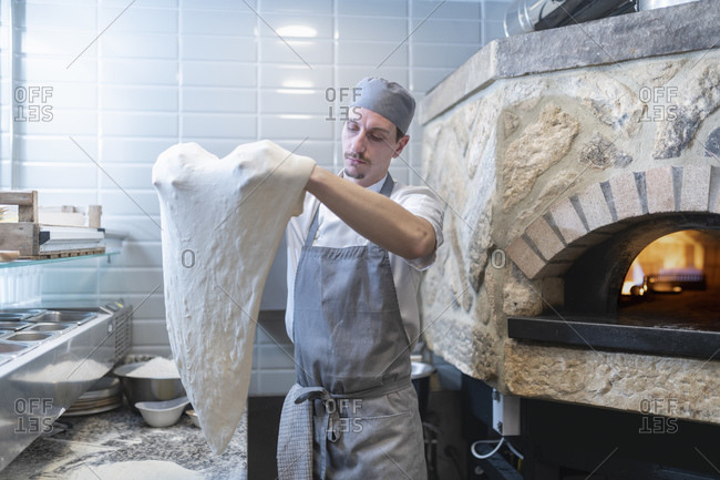Chef shaping the dough for Pinsa Romana, a Roman style pizza blend reducing sugar and saturated fat, containing rice and soy with less gluten