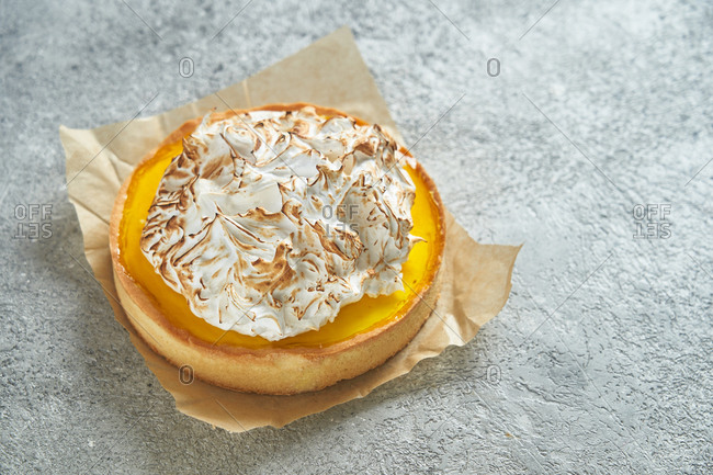 Lemon meringue tart on gray background