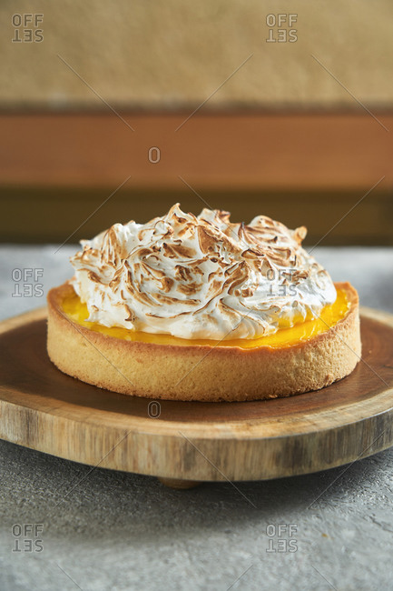 Lemon meringue tart on a wooden stand
