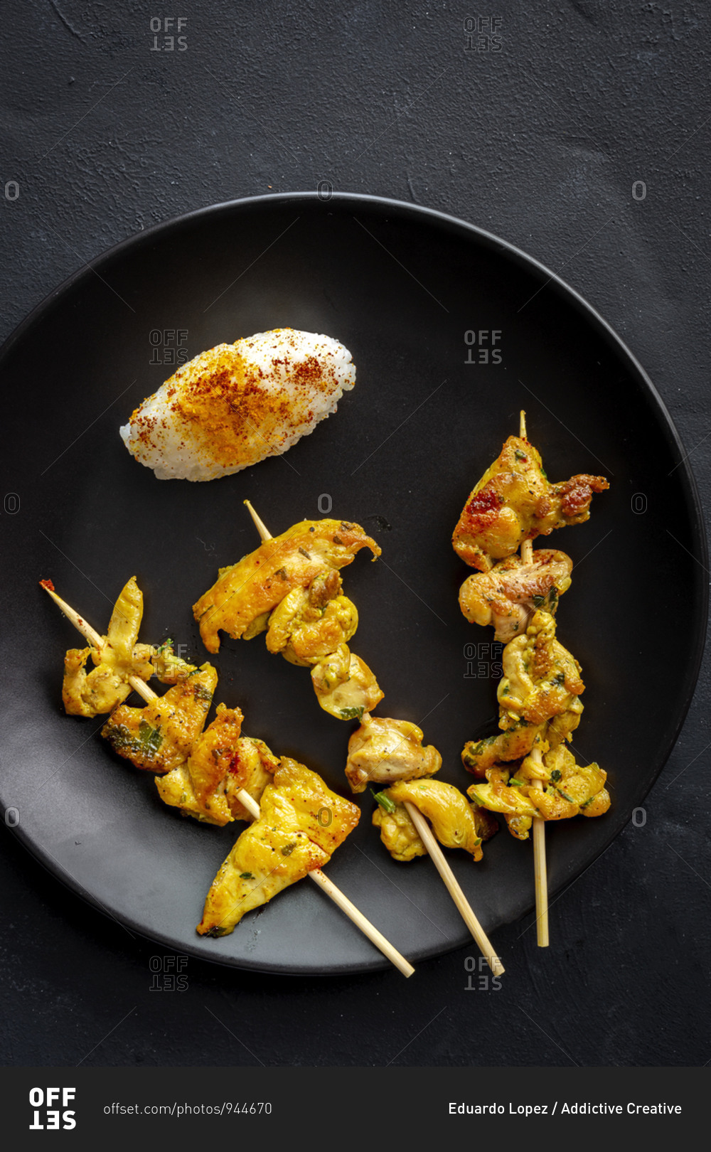 Homemade Moorish skewers with rice of meat with spices. Typical oriental food from above on dark background. Flat lay. Top view