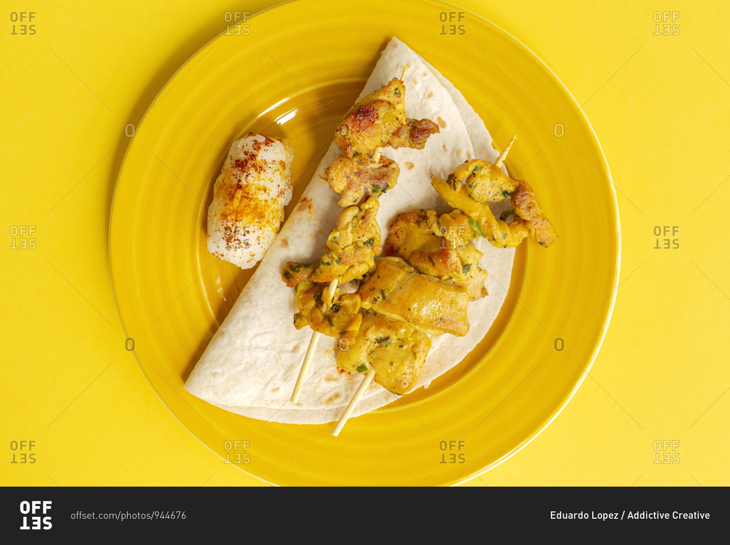 Homemade Moorish skewers with rice of meat with spices. Typical oriental food from above on yellow background. Flat lay. Top view