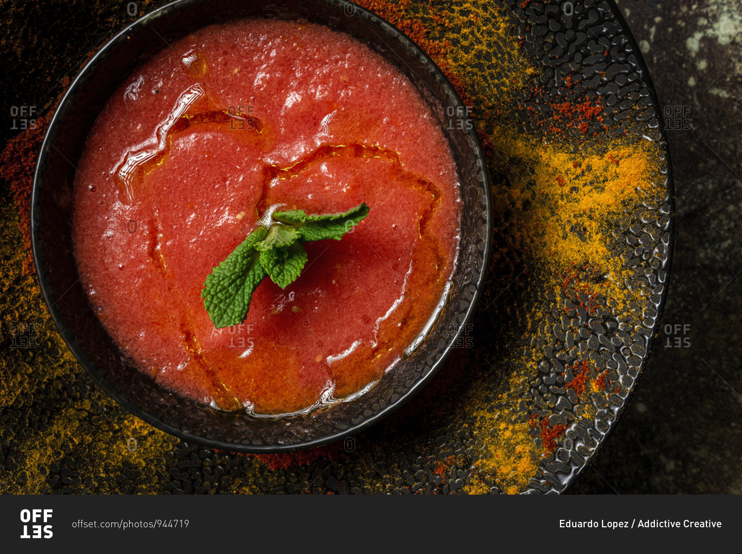 Healthy Homemade Tomato Soup with Bread, Mint and Olive Oil on Dark Background from above. Vegan food concept
