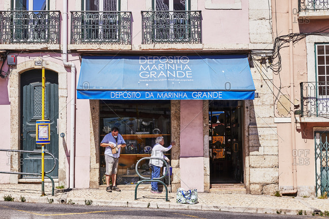 Lisbon, Portugal - July 19, 2019: People outside of shop in downtown Lisbon
