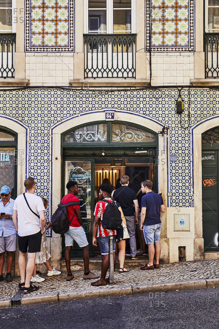 Lisbon, Portugal - July 21, 2019: Patrons waiting outside of a gelato shop
