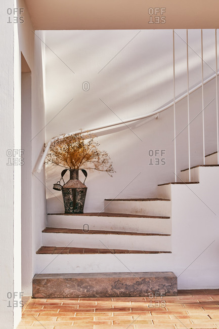 White steps with brick treads on decorative dried flower arrangement