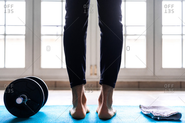 Barefoot woman stretching on pilates ladder barrel Stock Photo by