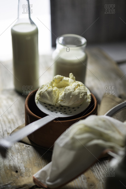 Homemade mascarpone cheese with a slotted spoon on a vintage atmosphere