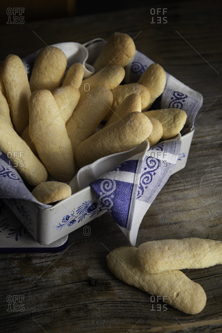 Homemade ladyfingers in a vintage metal box on a wooden background