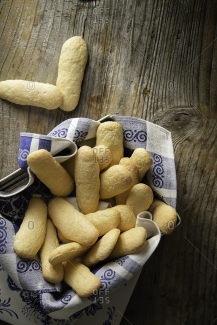 Homemade ladyfingers in a vintage metal box on a wooden background