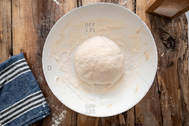 Overhead view of a round ball of pizza dough