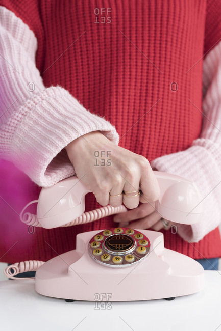 Woman holding vintage phone in her hand