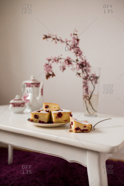 Serving of cherry cake with cherry blossoms and tea