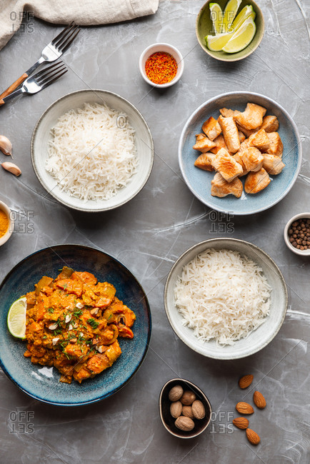 Indian food Curry butter chicken with cashew and basmati rice on gray background