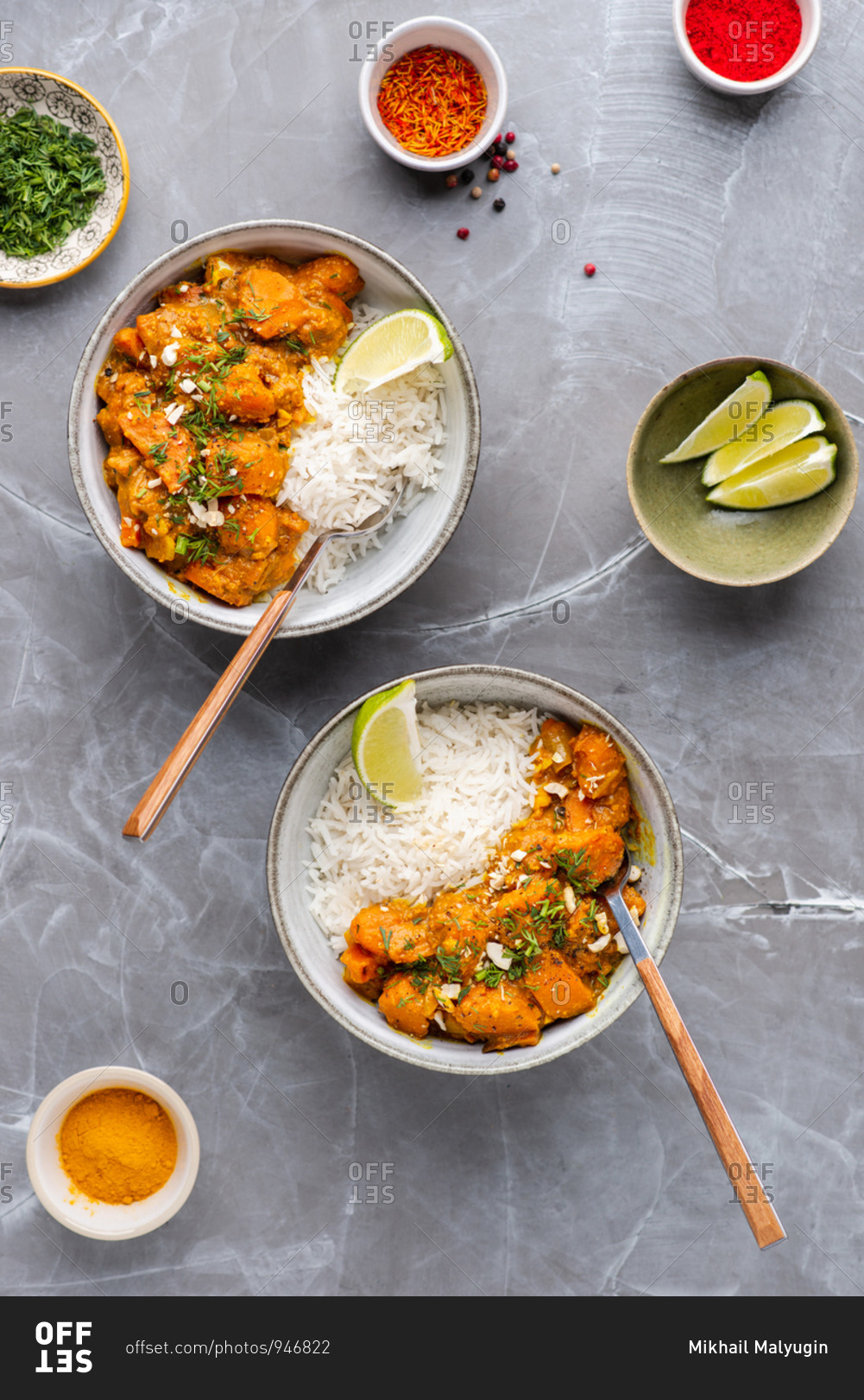 Indian food Curry butter chicken in bowls with basmati rice on gray background