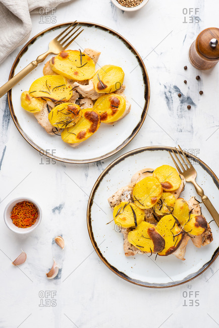 Roasted chicken fillet with baked sliced potato with rosemary