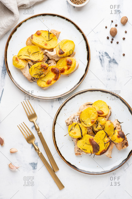 Roasted chicken fillet with baked sliced potato with rosemary