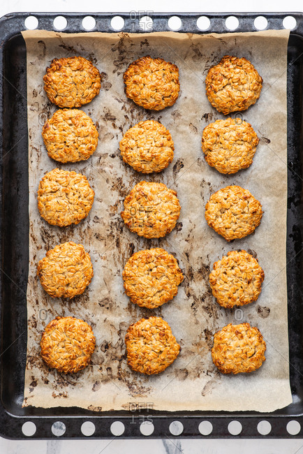 Overhead view of freshly baked oatmeal cookies on baking tray