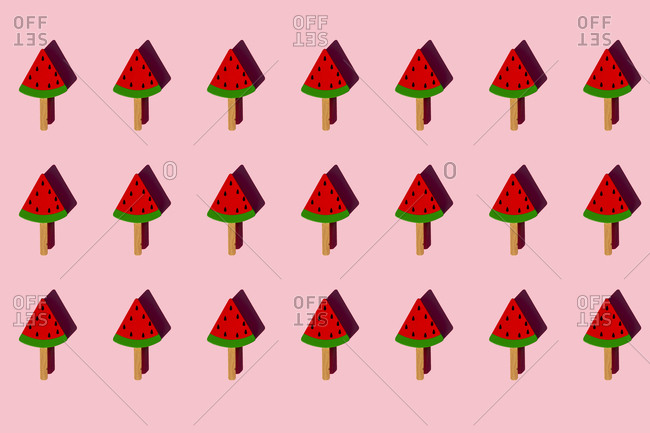 Pattern of popsicle sticks with toy watermelon slices