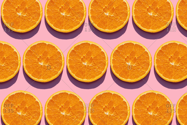 Pattern of orange slices against pink background