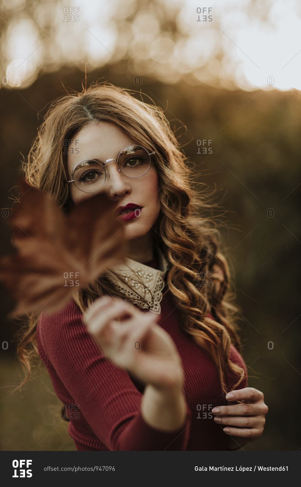 Portrait of fashionable woman with autumn leaf