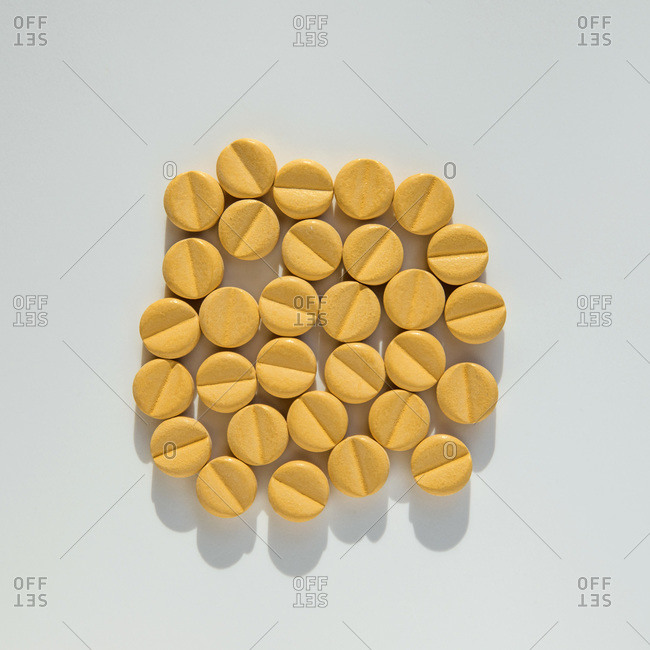 Studio shot of bunch of yellow pills