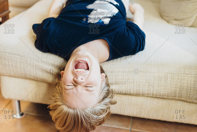 Screaming boy lying on couch