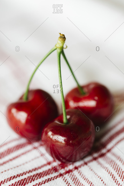 Ripe cherries on a red striped napkin